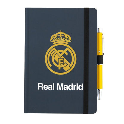 It has 96 dotted sheets and is A5 in size. Includes a pen that projects the image of the coat of arms. Features a hard cover with elastic band for closure. It has a bookmark ribbon and an inside pocket.